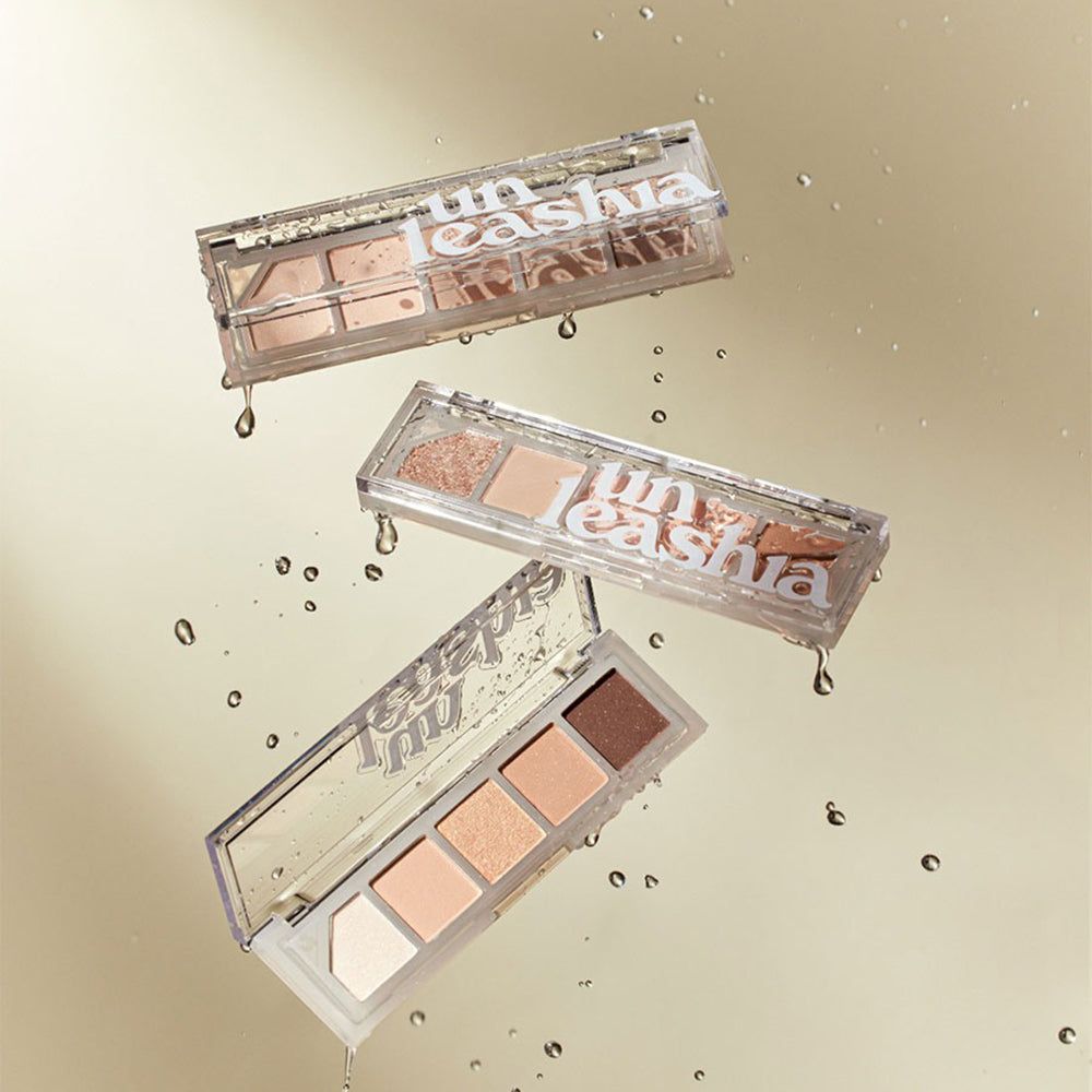 Tre palette UNLEASHIA Mood Shower trasparenti, con ombretti. Gocce d'acqua. Nome del prodotto sulle palette.