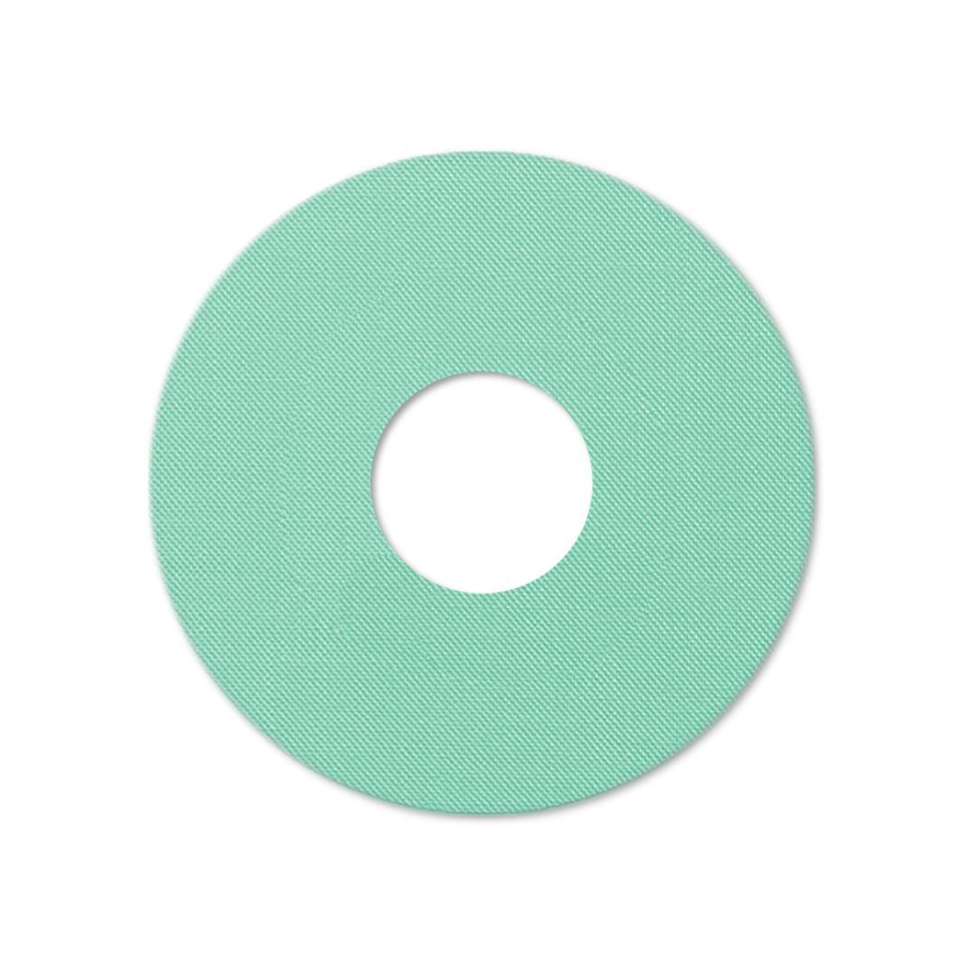 Anello di fissaggio rotondo, color menta, con foro centrale. Tessuto.