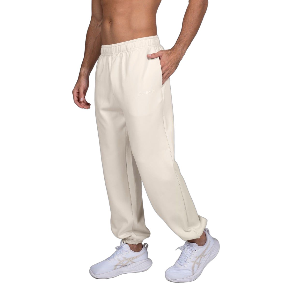 Pantaloni da jogging beige da uomo, vista laterale con elastico in vita e ai polsini.