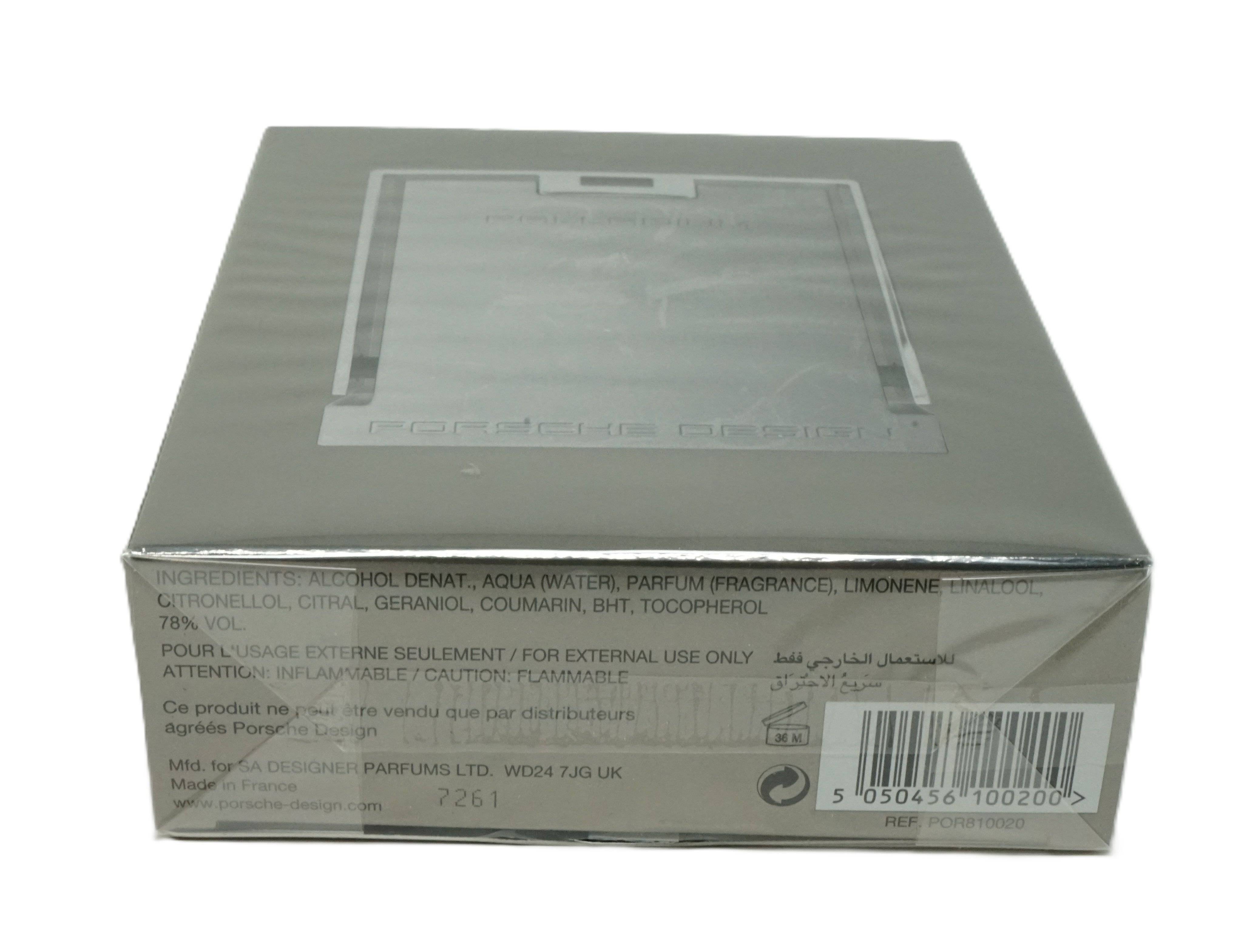 Scatola grigia, vista dall'alto. Finestra trasparente. Testo: Ingredienti, Pour usage externe seulement, Codice a barre.