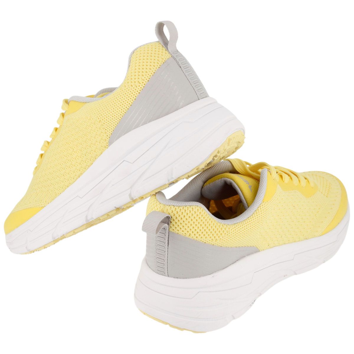 Sneakers gialle con suola bianca. Tomaia in mesh. Dettagli grigi. Prospettiva.