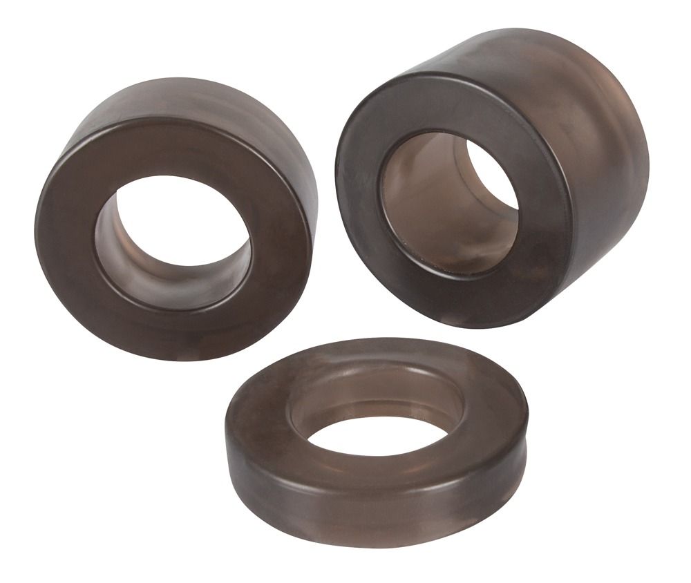 Tre anelli scuri con apertura centrale. Diverse dimensioni, in materiale scuro.