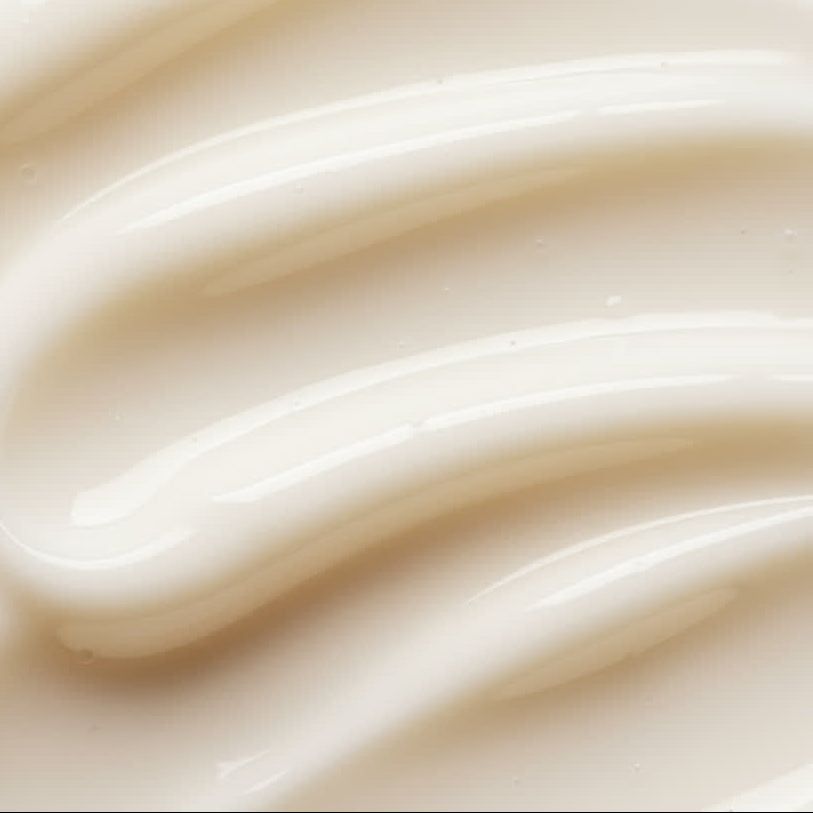 Primo piano di crema bianca cremosa con texture ondulata. Superficie lucida.