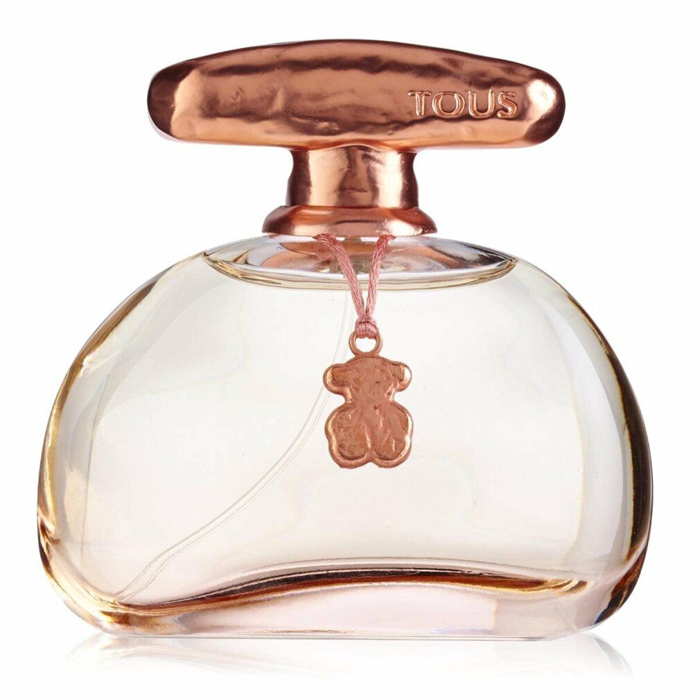 Flacone di profumo con tappo rosa e ciondolo. Flacone rotondo e trasparente. Ciondolo a forma di orsetto.