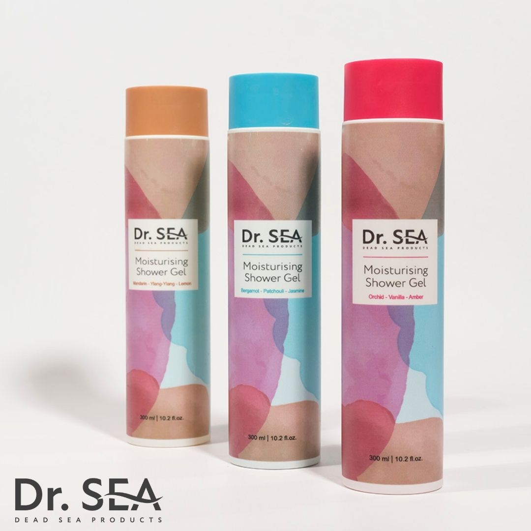 Tre flaconi di gel doccia. Scritta: Dr. SEA, Moisturising Shower Gel. Colori: blu, rosa, arancione. Profumi: gelsomino, patchouli, vaniglia.