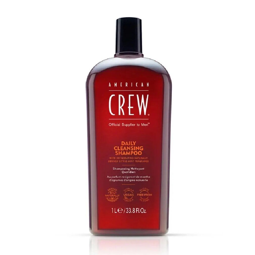 Flacone rosso American Crew Daily Shampoo. Tappo nero. Testo: Daily Cleansing Shampoo, 1L/33.8 Fl. Oz.