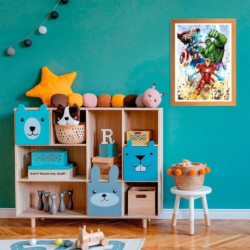 Puzzle con cornice degli Avengers su una parete turchese. Mobile contenitore con giocattoli.