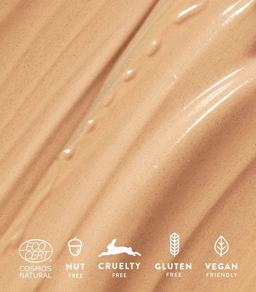 Primo piano di crema con loghi: Cosmos Natural, Nut Free, Cruelty Free, Gluten Free, Vegan Friendly.