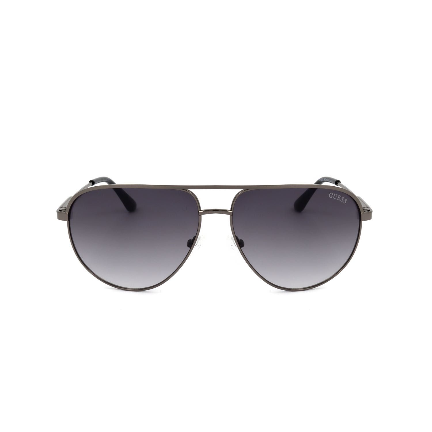 Occhiali da sole a goccia con lenti scure a specchio e montatura in metallo grigio. Logo Guess sulla stanghetta.
