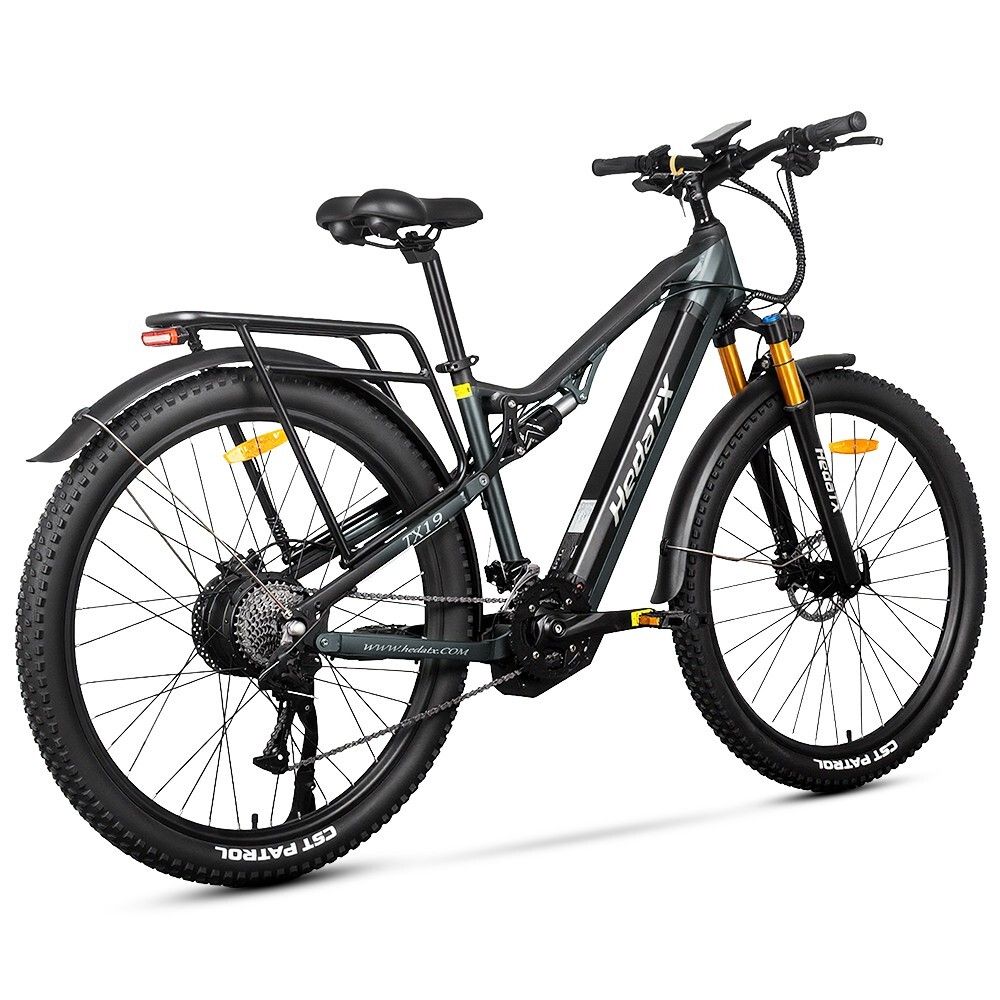 E-bike grigio HedaTX TX19. Pneumatici neri, portapacchi, sospensioni. Forcella gialla. 27 velocità. Scritta HedaTX.