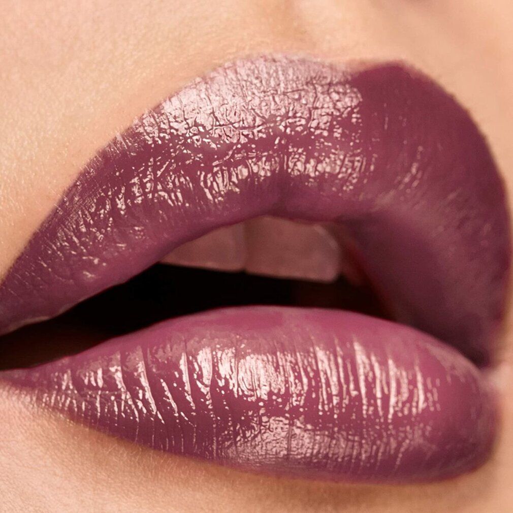 Primo piano di labbra truccate con un rossetto malva. Le labbra sono leggermente socchiuse.