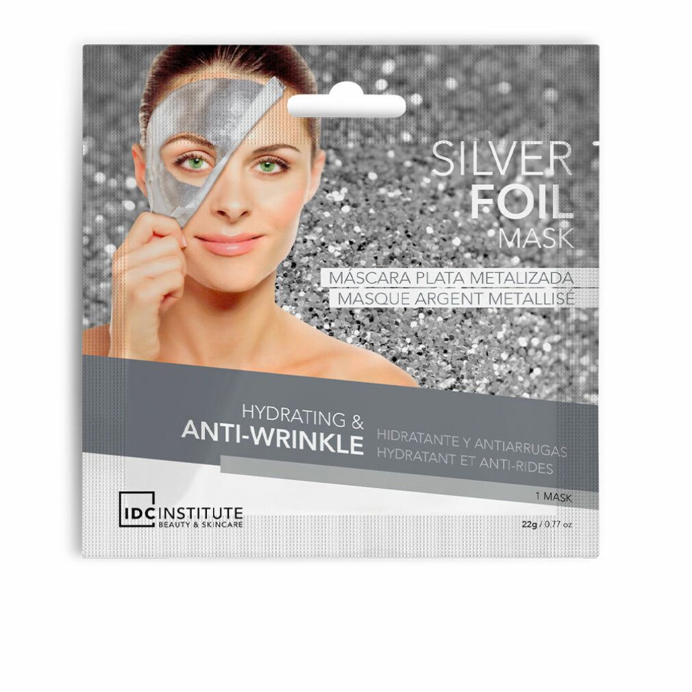 Confezione maschera in foglio d'argento. Donna con maschera. Testo: Silver Foil Mask, Hydrating & Anti-Wrinkle, IDC Institute.