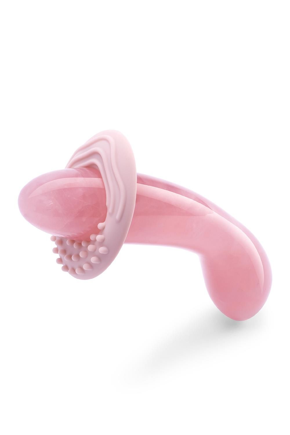 Prodotto benessere rosa con accessorio. Superficie liscia, forma arrotondata. Accessorio aggiuntivo con borchie.