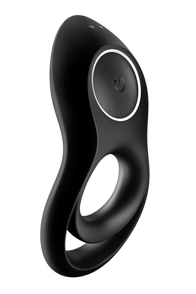 Vibratore ad anello nero con due fori e pulsante di accensione. Due piccoli punti in alto.