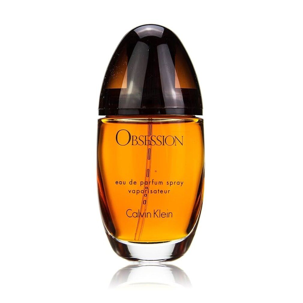 Flacone di profumo marrone ovale, tappo scuro. Scritta Obsession e Calvin Klein. Eau de Parfum Spray.