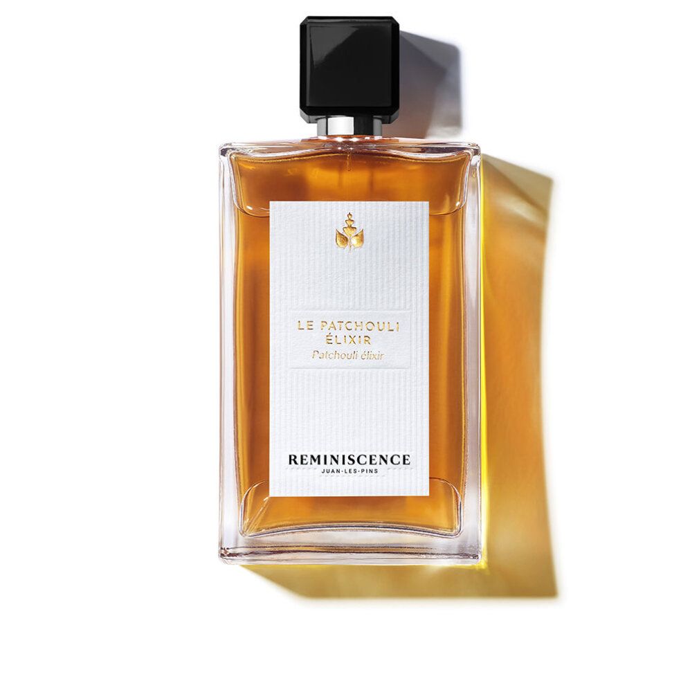 Flacone di profumo con tappo nero. Etichetta con testo: Le Patchouli Elixir, Reminiscence. Forma rettangolare, liquido trasparente.