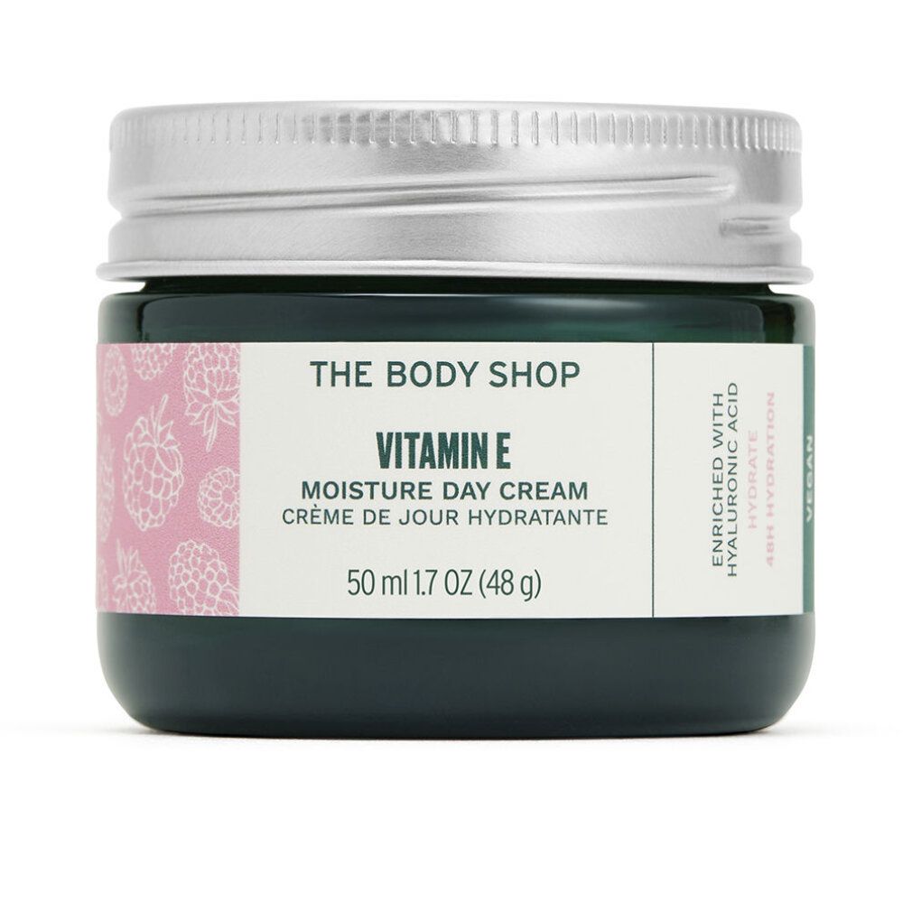 Vaso di vetro verde scuro con coperchio argentato. Etichetta "Vitamin E Moisture Day Cream" e "The Body Shop". Motivo rosa. 50 ml.