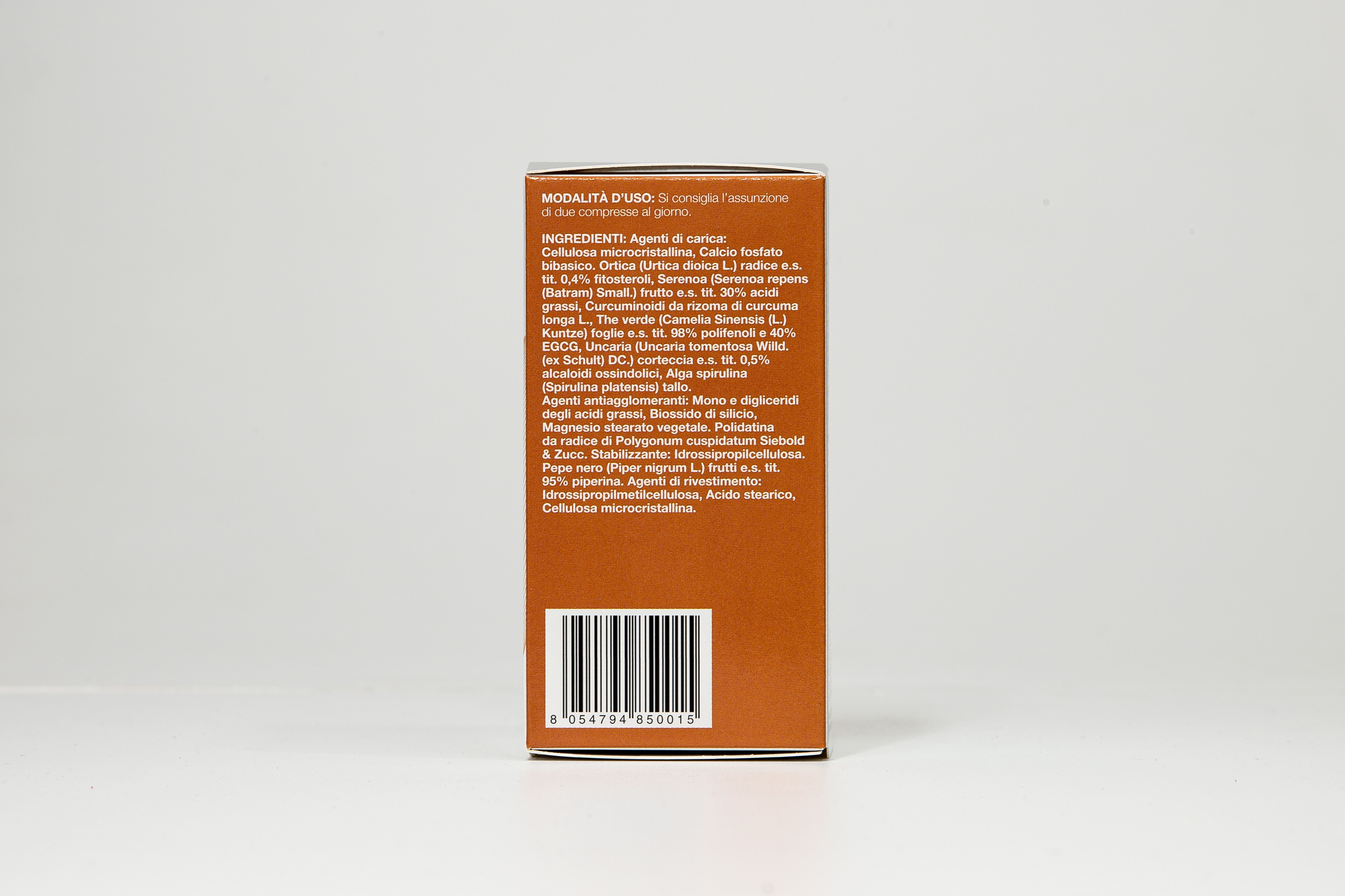 Retro di una scatola arancione. Testo: Ingredienti, codice a barre. PREVENANT Prostata.