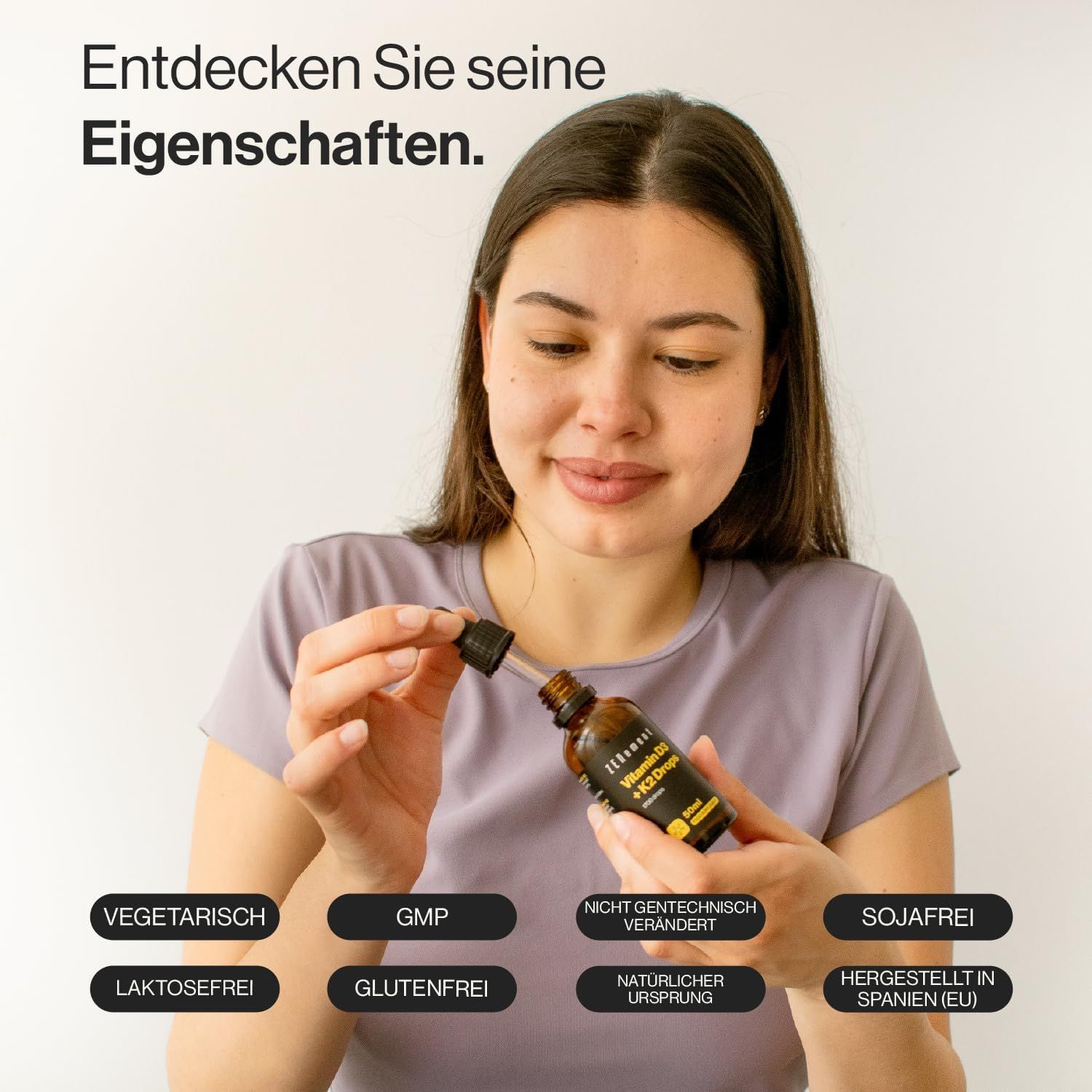 Donna tiene flacone contagocce. Flacone: Zenement Vitamina D3 + K2 Gocce. Etichette: vegetariano, GMP, non OGM, senza soia, senza lattosio, senza glutine, origine naturale, prodotto in Spagna.