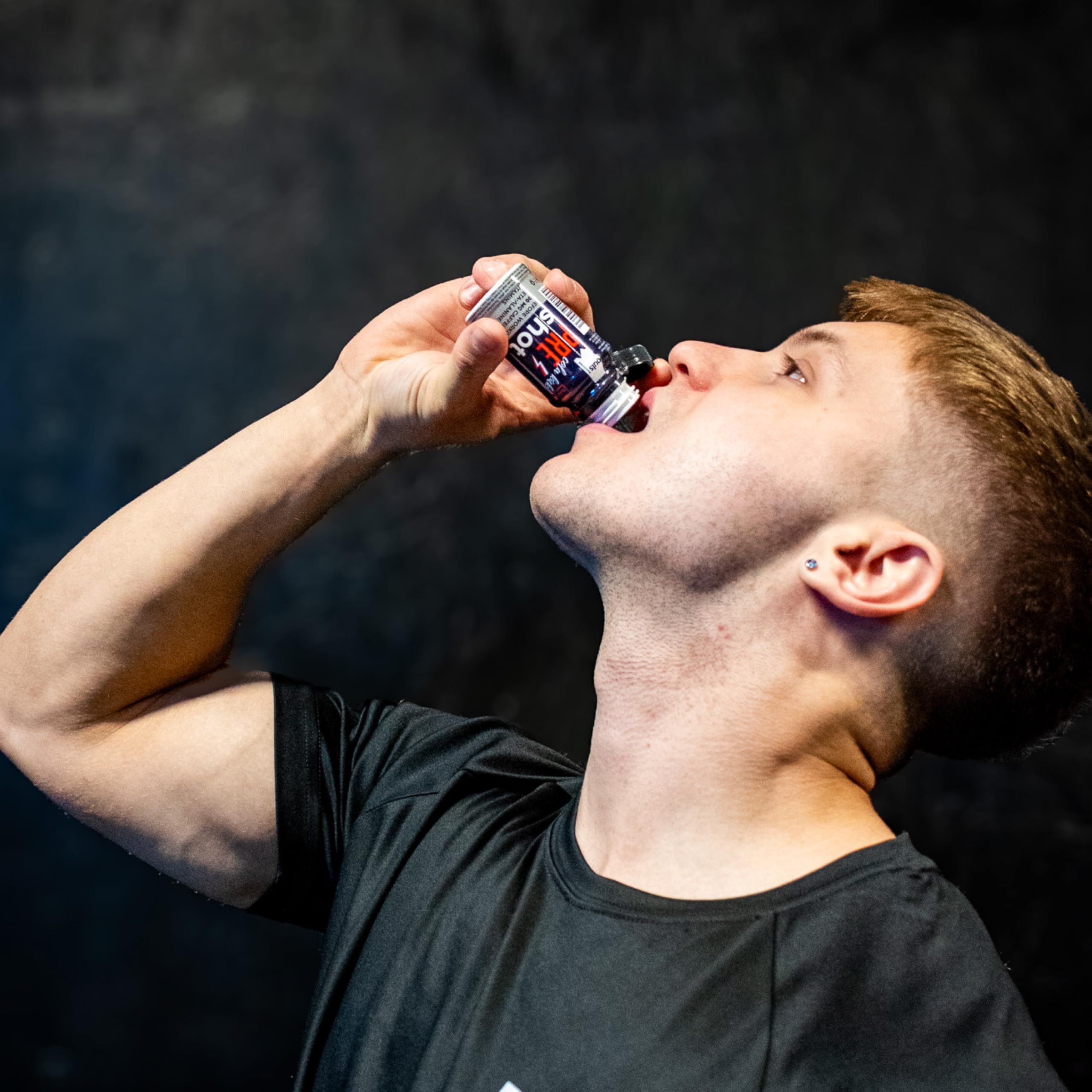 Un uomo beve uno shot pre-allenamento Puls Nutrition.