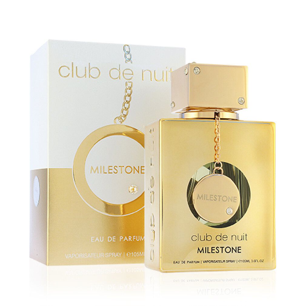 Flacone dorato con confezione bianca. Scritta 'Club de Nuit Milestone'. Flacone con pendente e strass.