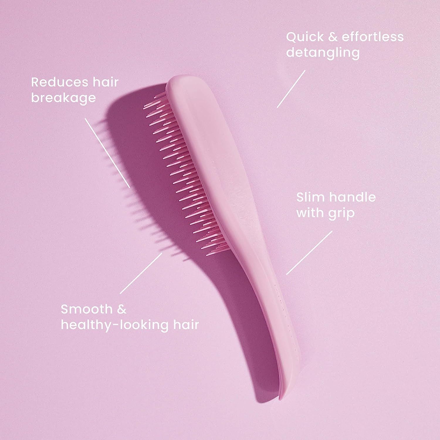 Spazzola rosa con testo. Testo: Riduce la rottura, districare velocemente, capelli lisci, manico sottile.
