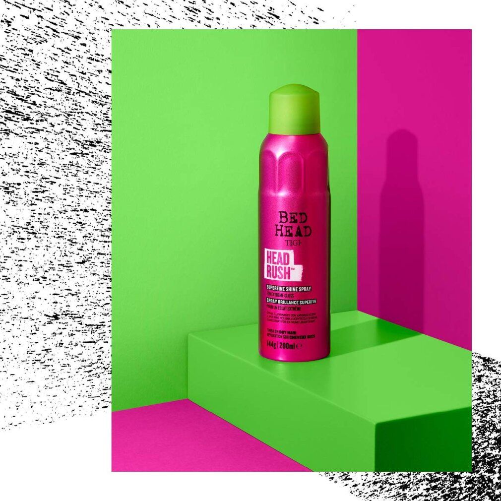 Flacone spray rosa con tappo verde su piattaforma verde. Bed Head Headrush. Sfondo: verde e rosa.