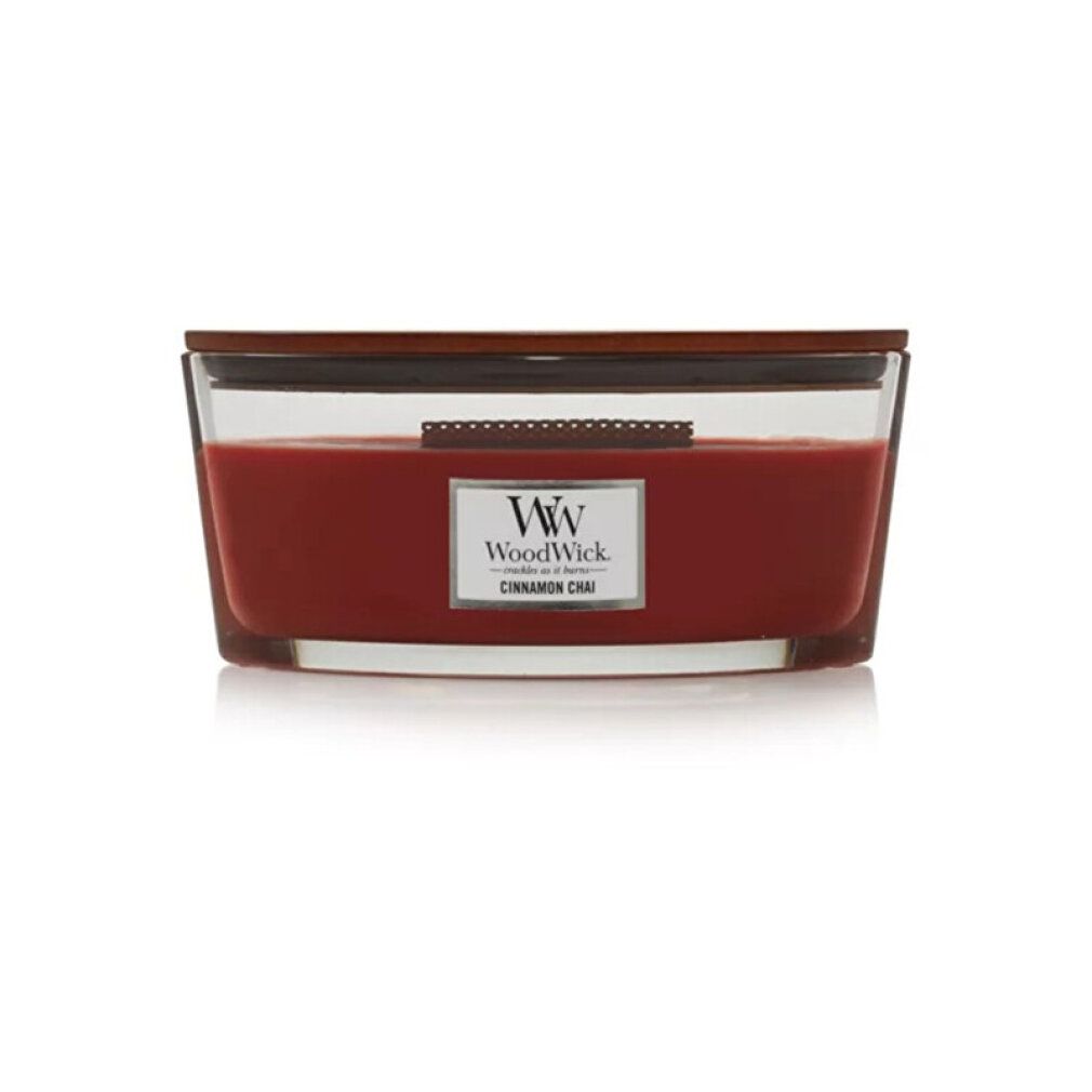 Candela Ellipse con coperchio in legno. Cera rossa in contenitore di vetro. Etichetta "WoodWick" e "Cinnamon Chai".