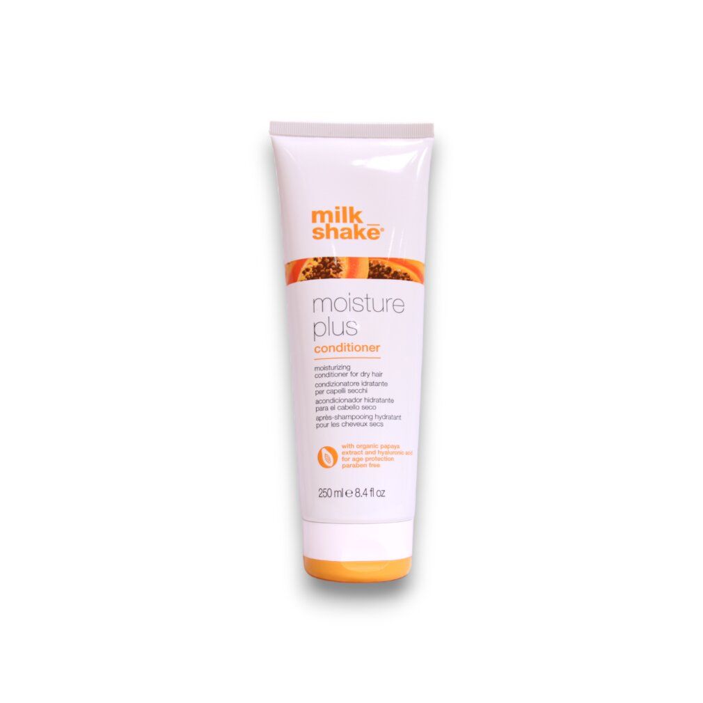 Tubo bianco con tappo arancione. Scritta: milk_shake moisture plus conditioner. Testo multilingue.