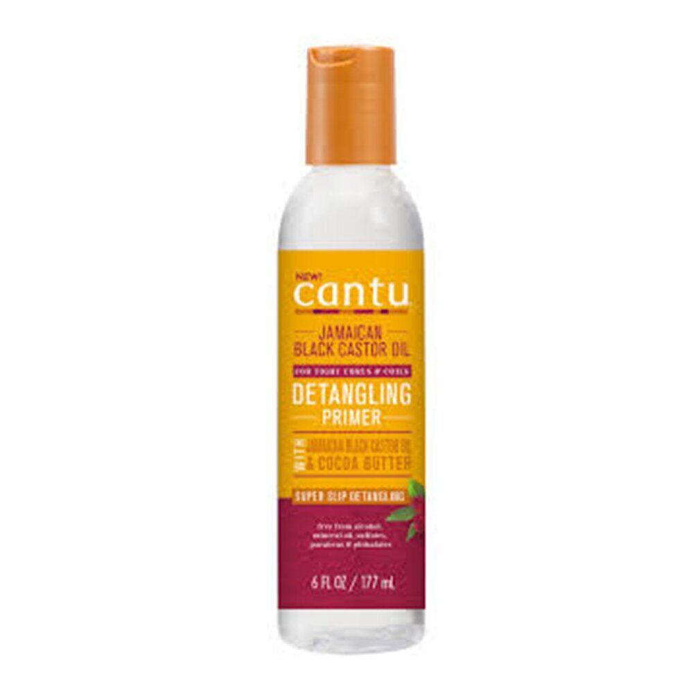 Flacone di Cantu Jamaican Black Castor Oil Detangling Primer. Etichetta giallo-arancione, base rossa. 6 fl oz / 177 ml.