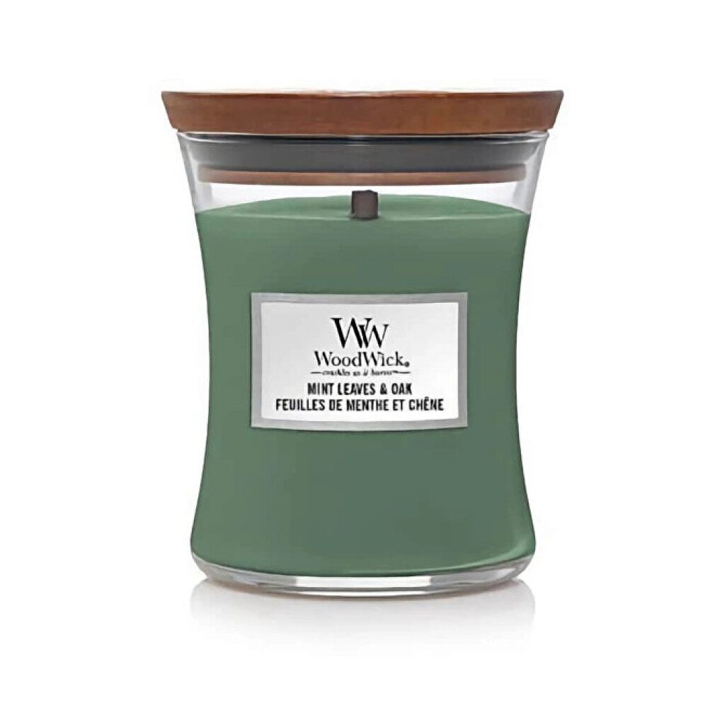 Candela verde a clessidra con coperchio in legno. Scritta: WoodWick, Mint Leaves & Oak. Contenitore di vetro.