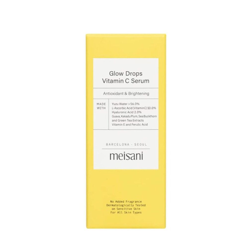 Confezione gialla con testo: Glow Drops Vitamin C Serum. Marchio: meisani. Contiene ingredienti. Per tutti i tipi di pelle.