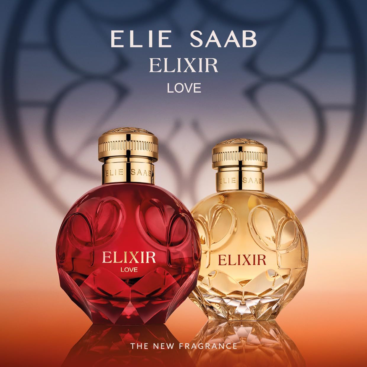 Due flaconi Elie Saab Elixir. Flacone rosso e dorato con tappo dorato. Scritta "ELIXIR LOVE".