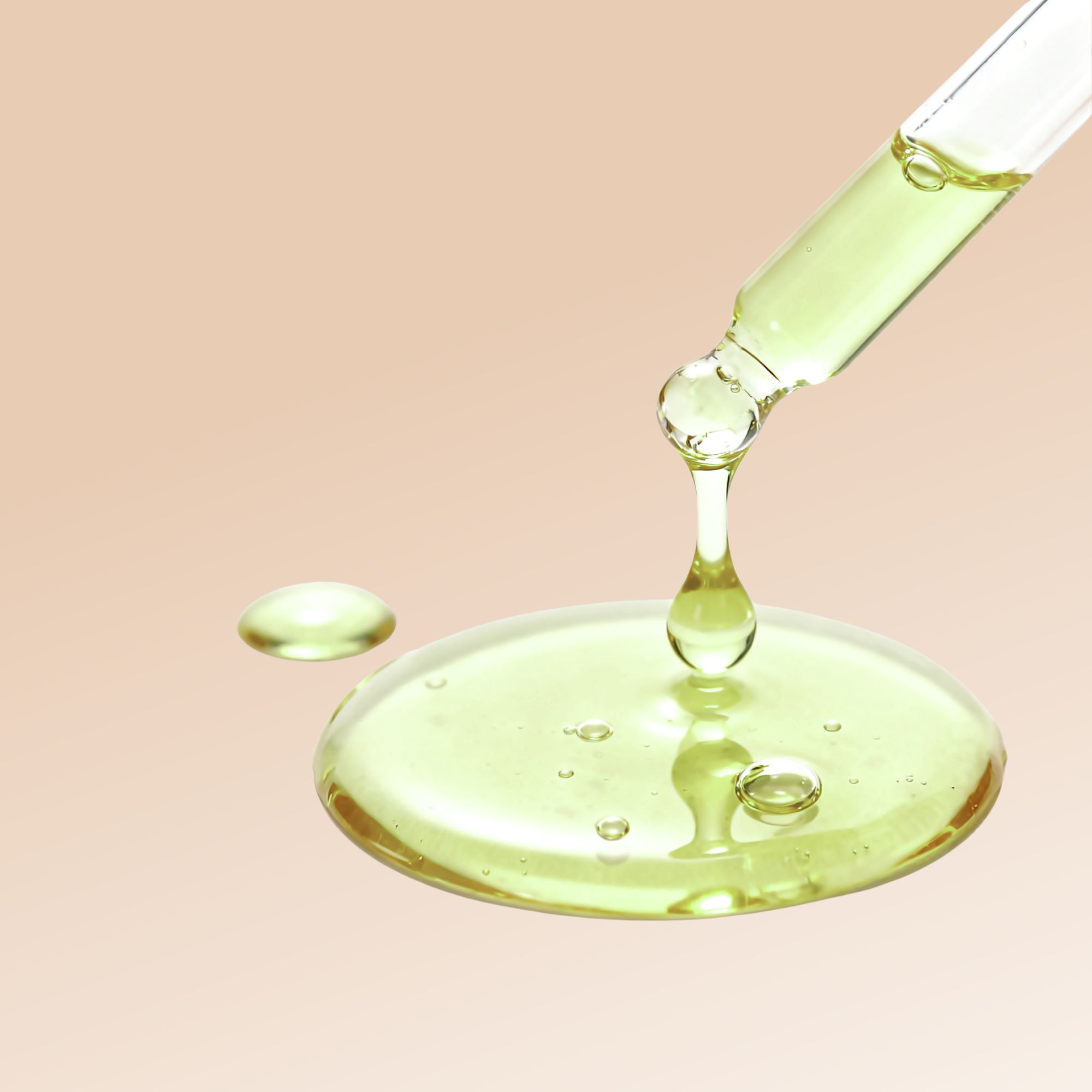 Liquido giallastro che gocciola da una pipetta. Una goccia su una superficie piana, altre gocce si formano.