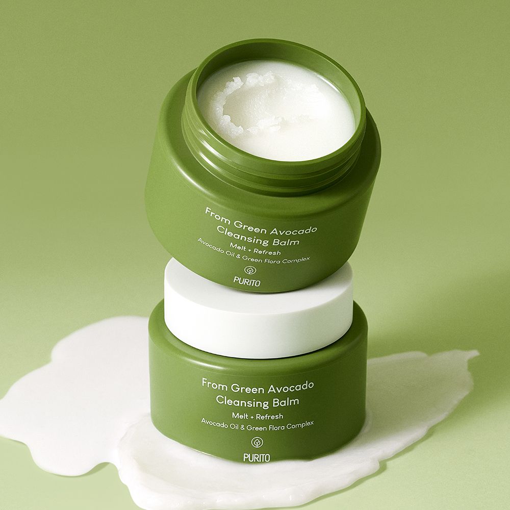Due vasetti verdi impilati uno sull'altro, con coperchio bianco e balsamo.