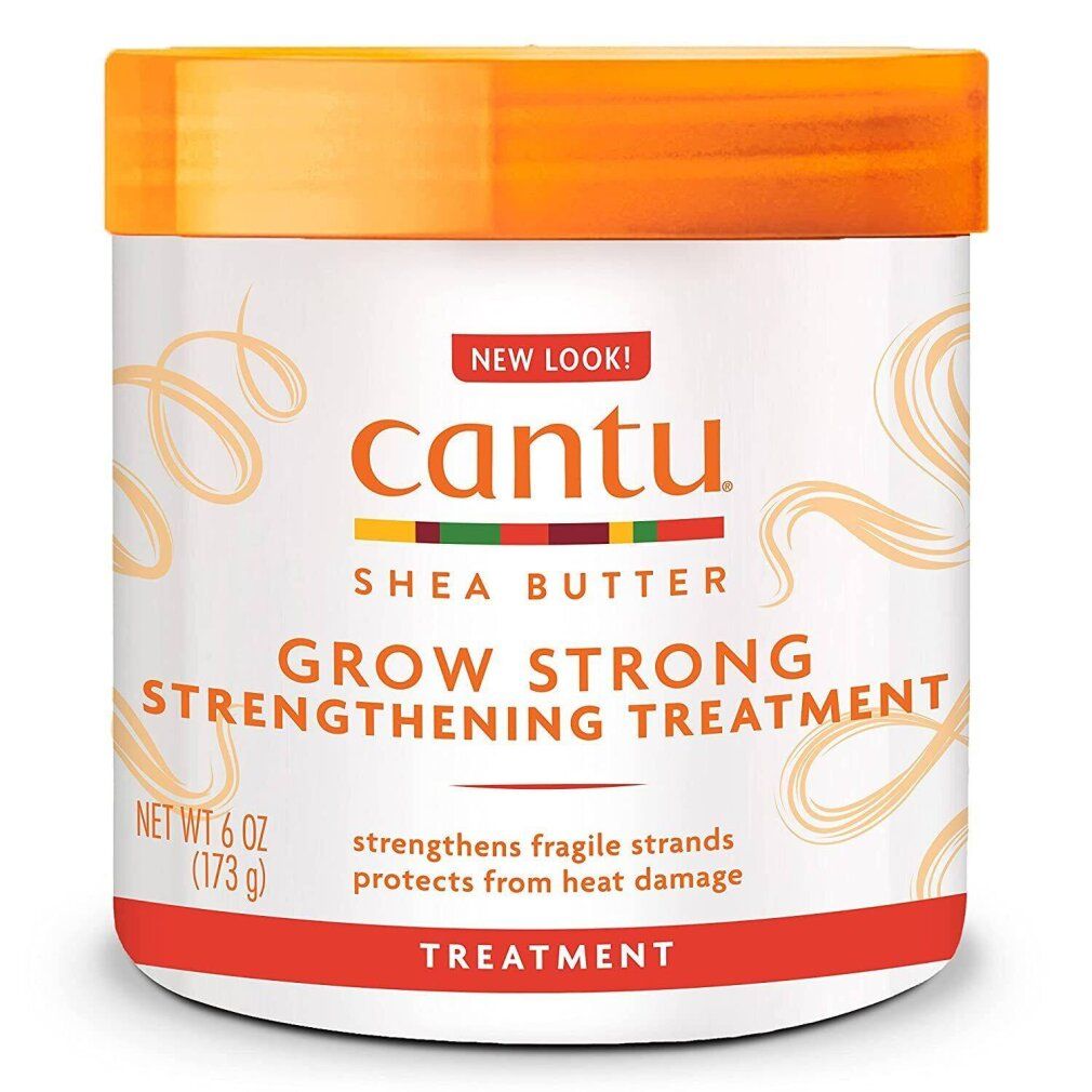 Vaso bianco con coperchio arancione. Scritta: Cantu, Shea Butter, Grow Strong, Strengthening Treatment. Netto 6 OZ / 173 g.
