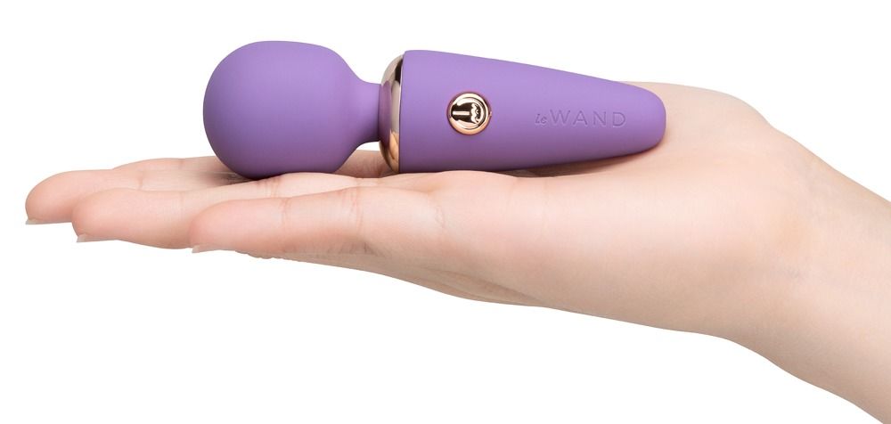 Vibratore viola con anello e pulsante oro rosa.