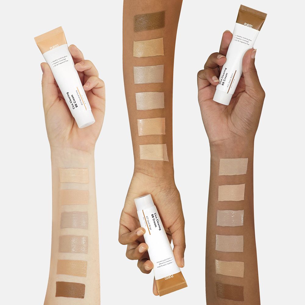 Mani con tubi di BB Cream e campioni di colore sui braccia. Diverse tonalità di pelle. Scritte: Purito, Cica Clearing BB Cream.