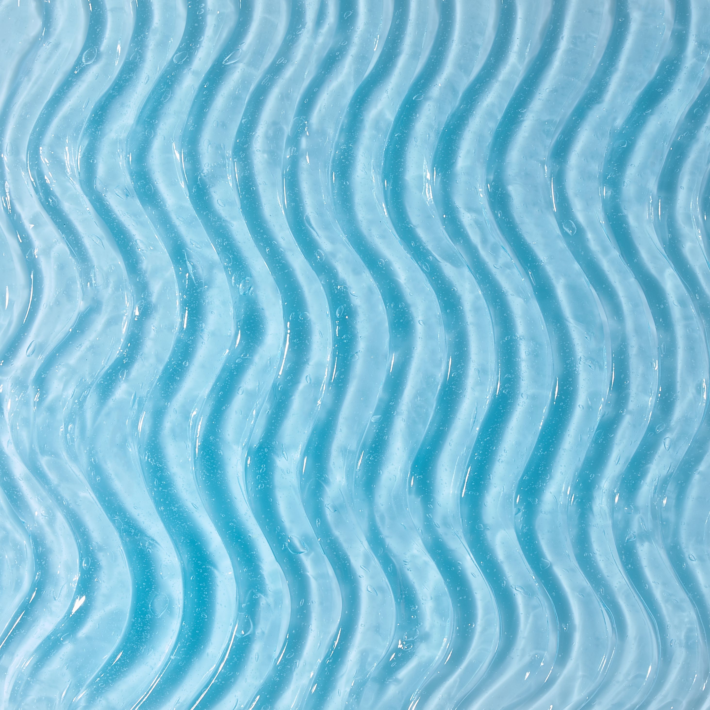Primo piano di gel blu con texture ondulata. Nessuna scritta visibile.