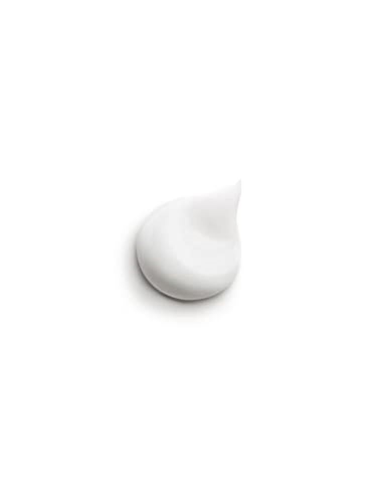 Goccia di crema bianca su sfondo bianco. Consistenza cremosa, forma a goccia.