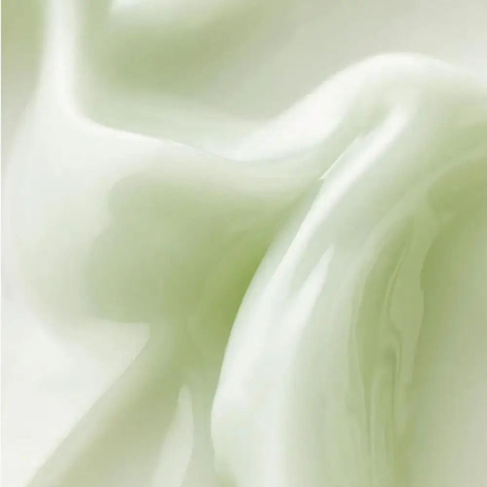 Primo piano della crema. La crema è verdastra. Sfondo: chiaro.