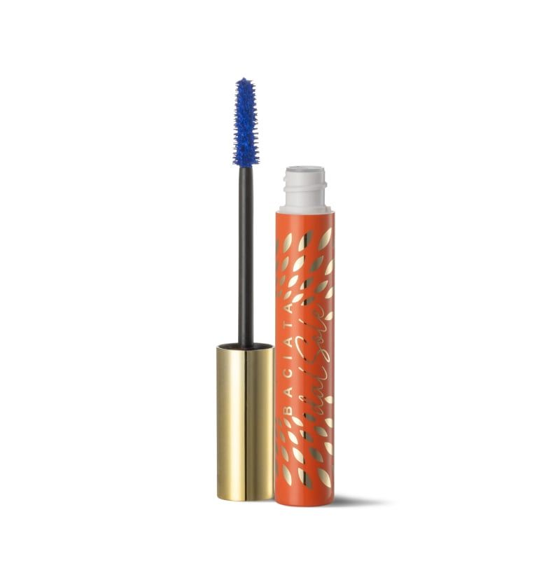Mascara con spazzola blu. Astuccio arancione con motivo a foglie dorate e scritta. Base mascara dorata.