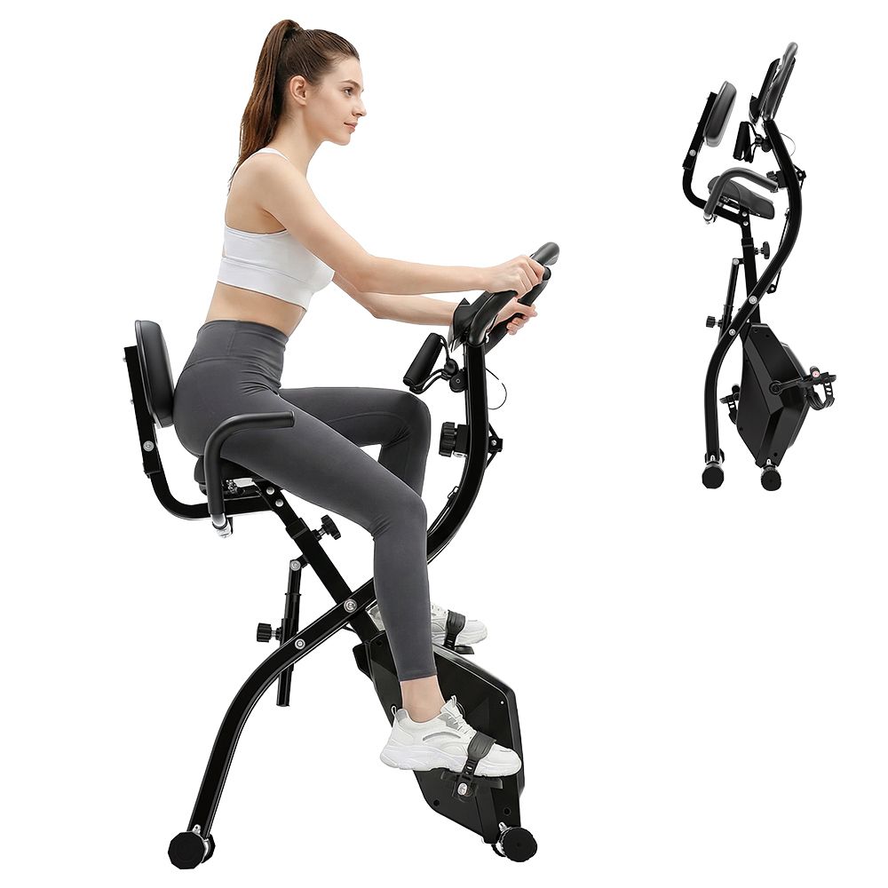 Donna su cyclette nera. Cyclette nera con sedile e manubrio.