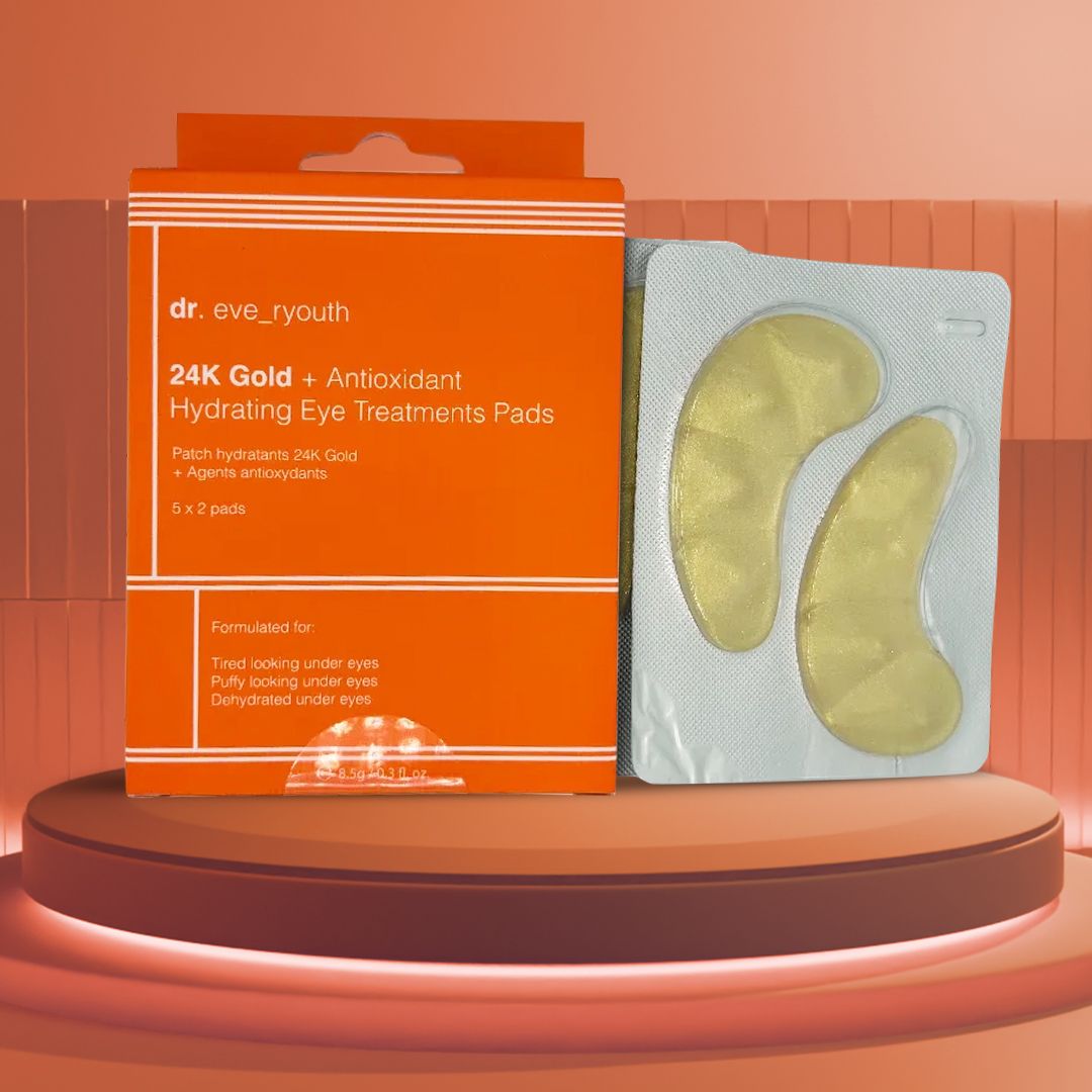 Scatola arancione e patch per occhi dorati in una confezione. Sulla scatola c'è scritto "dr. eve_ryouth 24K Gold + Antioxidant Hydrating Eye Treatments Pads".