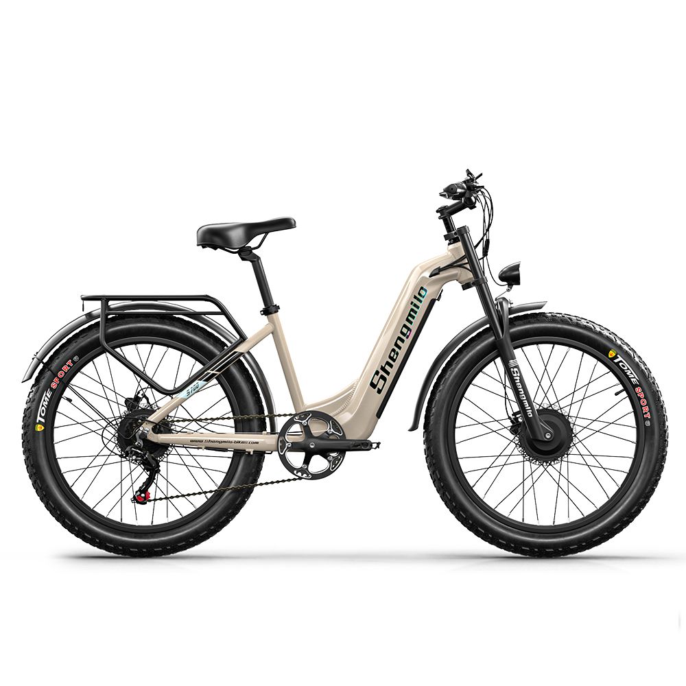 E-bike, vista laterale. Telaio beige, pneumatici neri. Marchio Shengmilo visibile. Portapacchi e parafanghi.