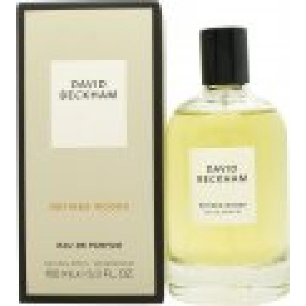 Flacone di profumo e confezione. Etichetta "DAVID BECKHAM REFINED WOODS EAU DE PARFUM". Bottiglia e scatola in vetro e cartone.