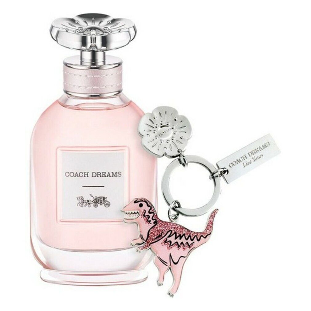 Flacone in vetro rosa con tappo argentato e ciondolo. L'etichetta riporta "COACH DREAMS" e un logo di carrozza.