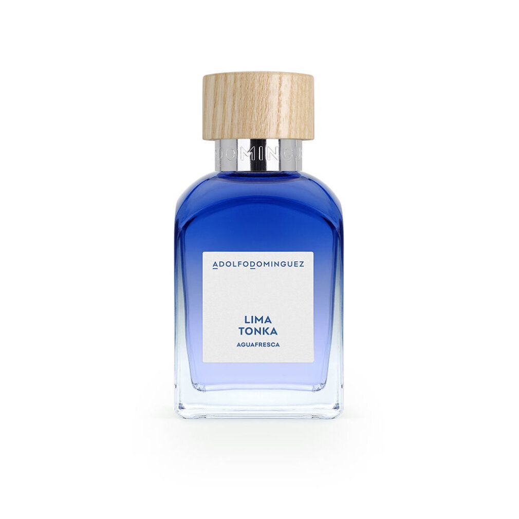 Flacone di profumo blu con tappo in legno. Scritta: Lima Tonka, Aquafresca. Flacone su sfondo bianco.