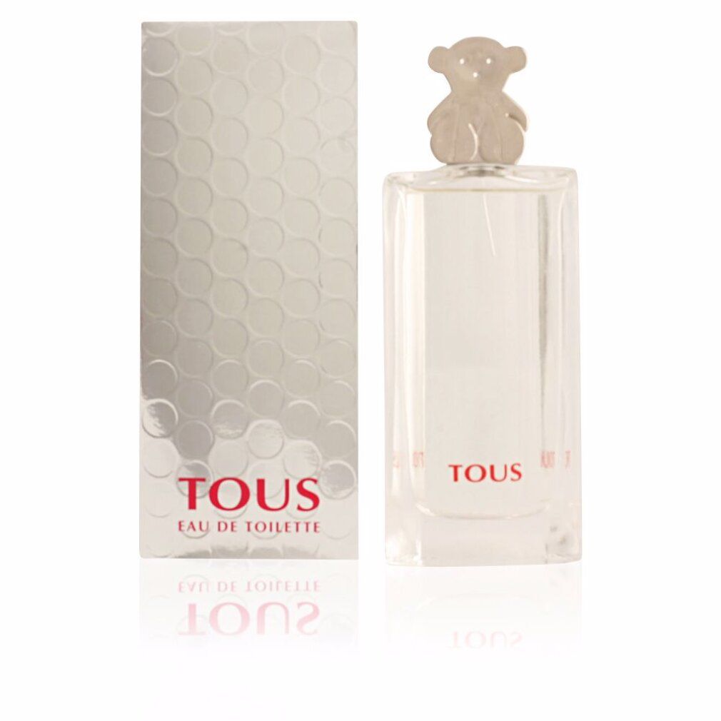 Flacone di profumo e scatola. Flacone con tappo a forma di orso. Scritta: Tous Eau de Toilette. Scatola argentata con motivo a nido d'ape. Riflesso.