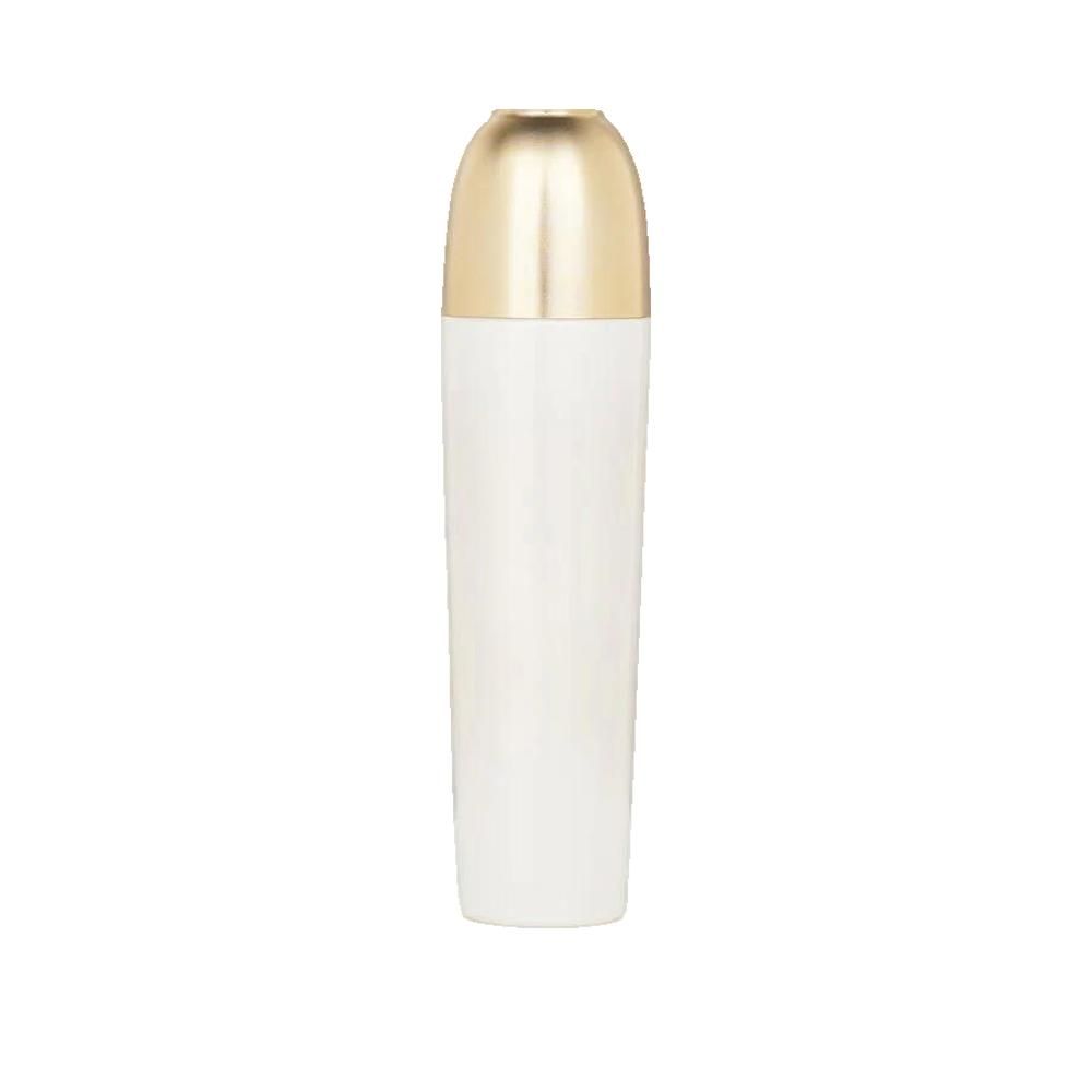 Flacone cilindrico bianco con tappo dorato. Il tappo è allungato e arrotondato. Nessun altro dettaglio visibile.